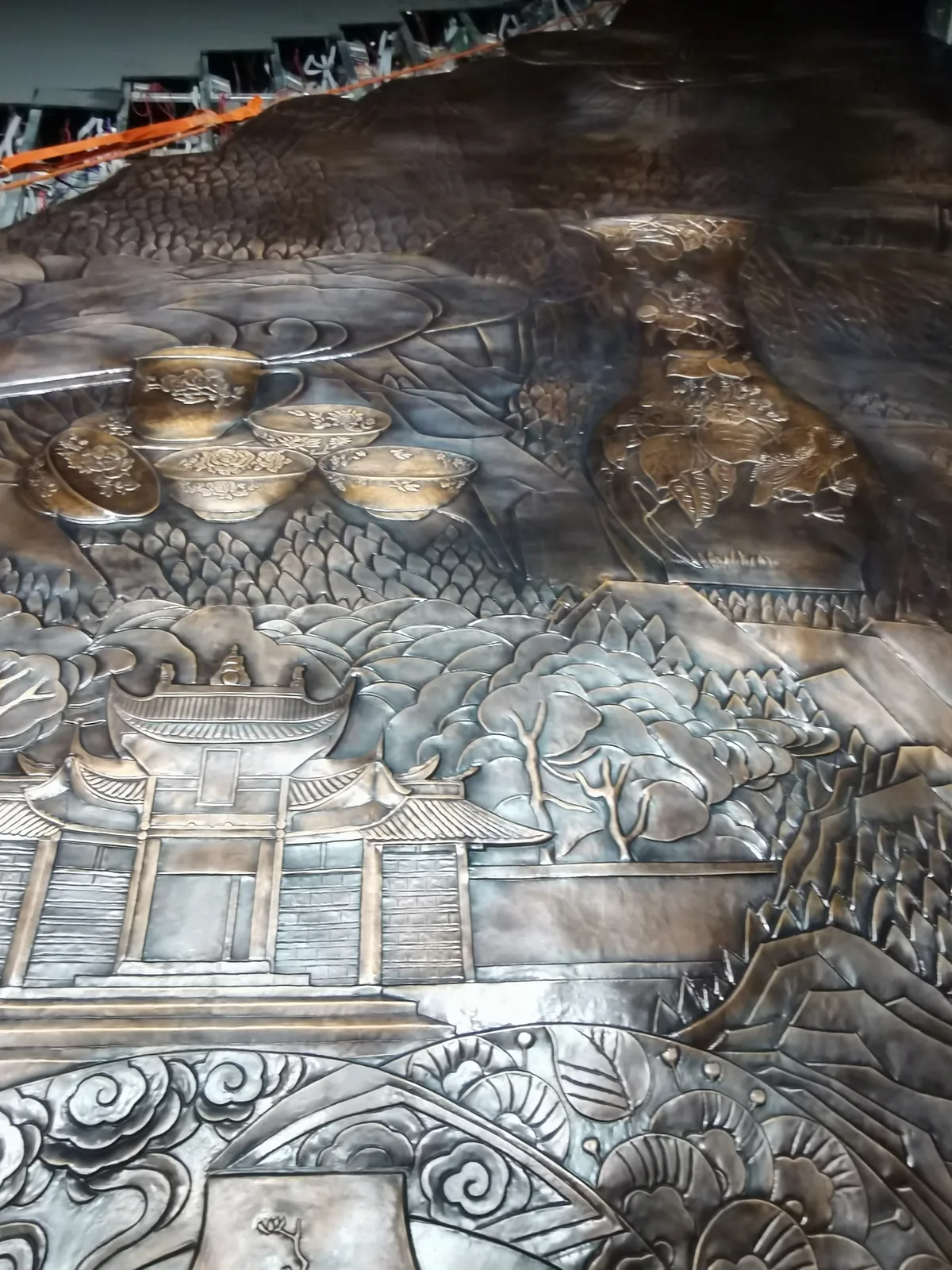 Large bronze sculpture wrapped in protective plastic film before transportation and crating.