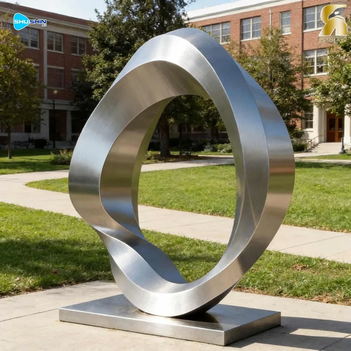 Polished stainless steel ring sculpture for outdoor landscape display.