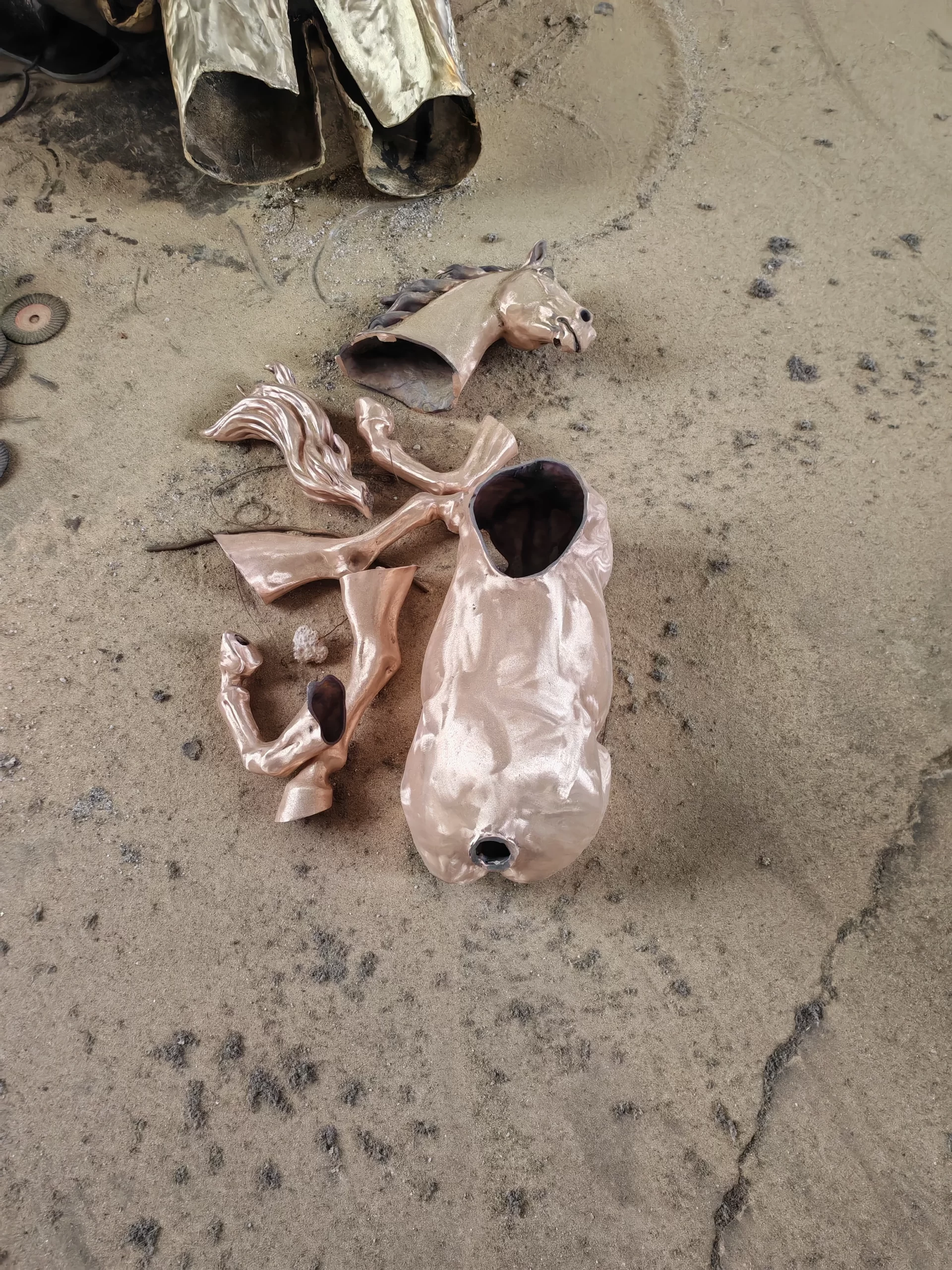 Bronze horse sculpture casting components prepared in a sand mold