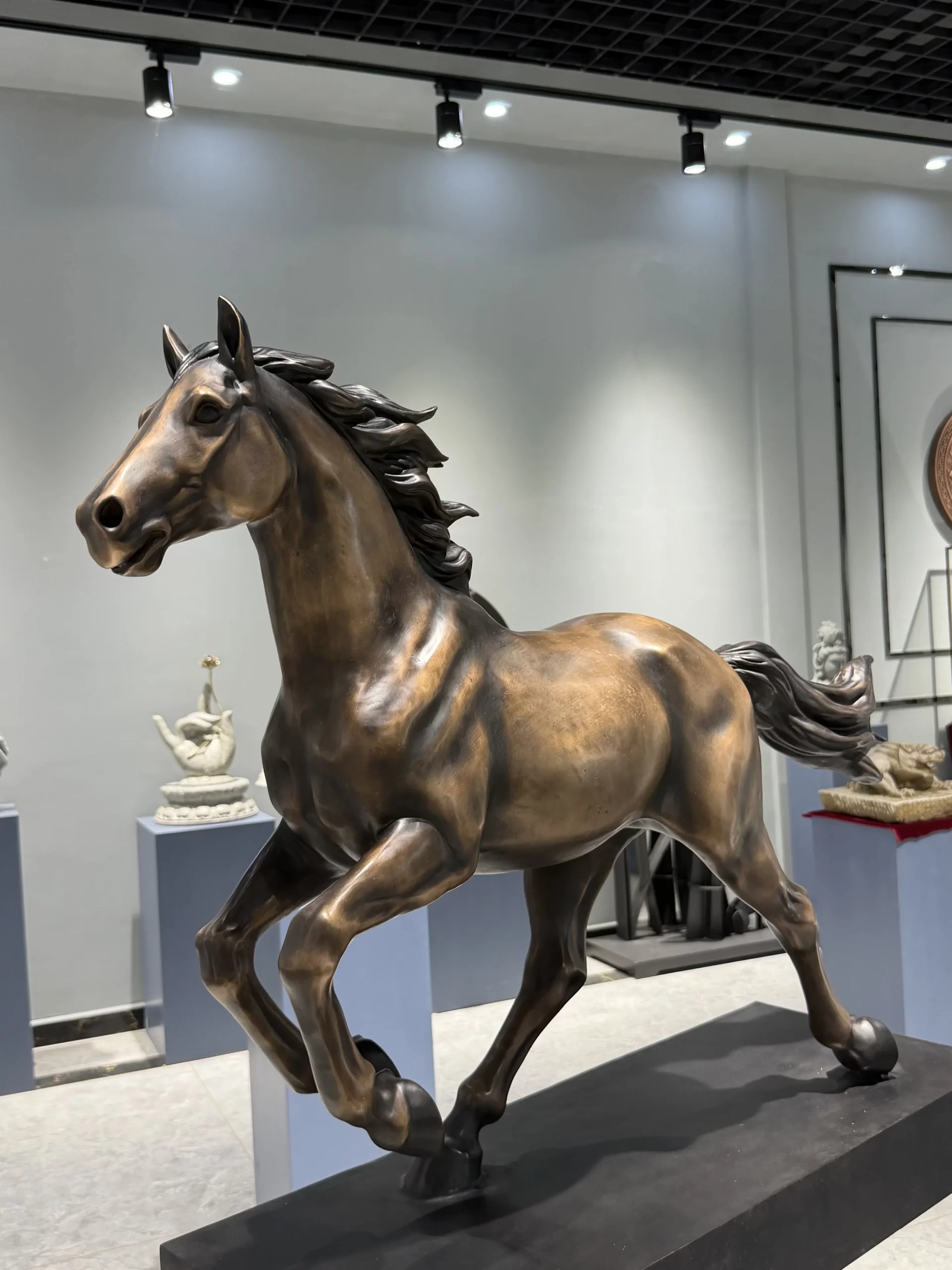 Finished bronze horse sculpture photographed from a low angle